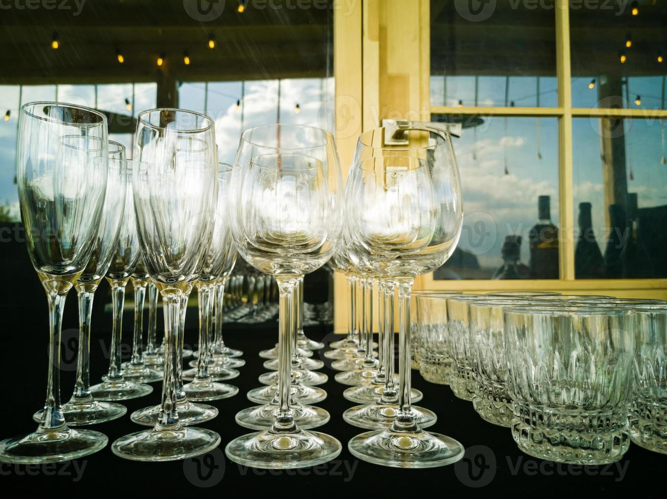 Wine glasses in row on bar photo