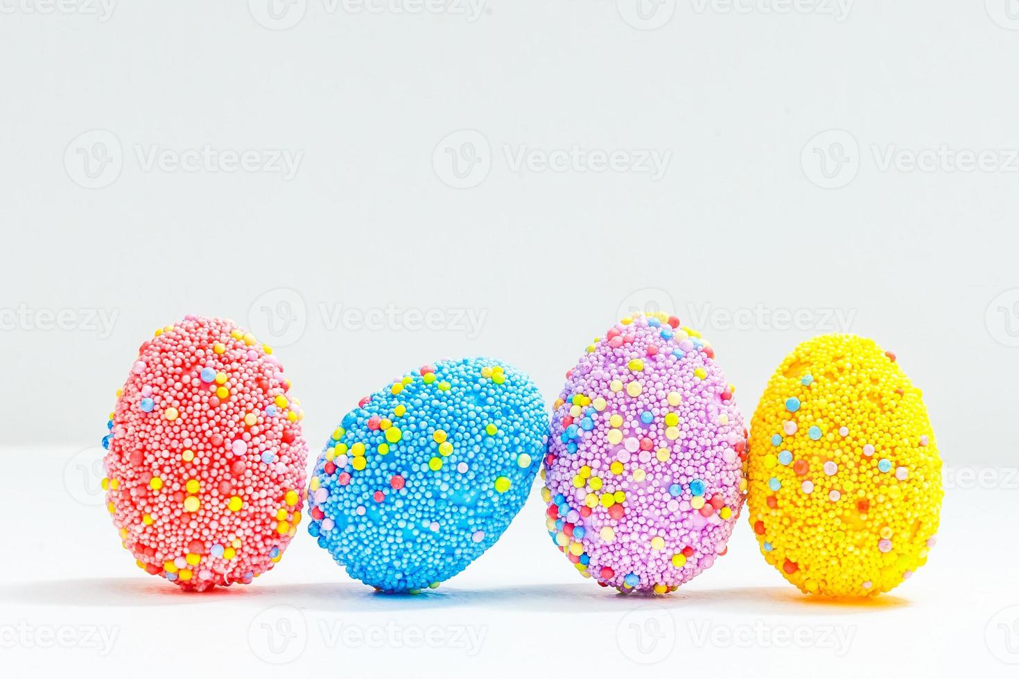 multi color eggs isolated on white photo