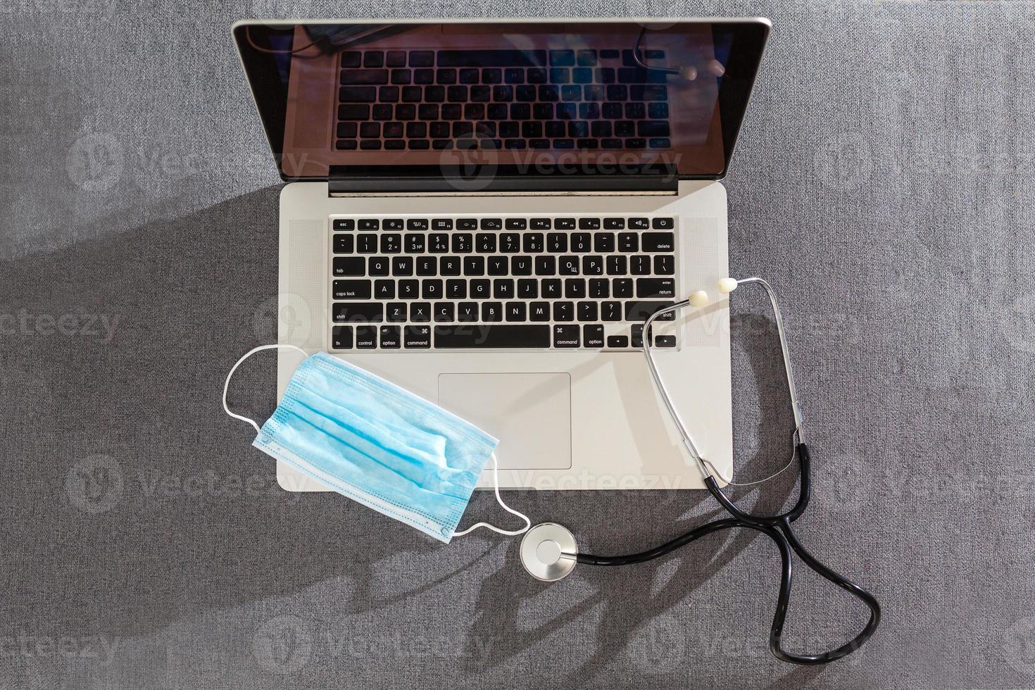 Computer or data analysis - Stethoscope over a laptop computer keyboard toned in blue photo