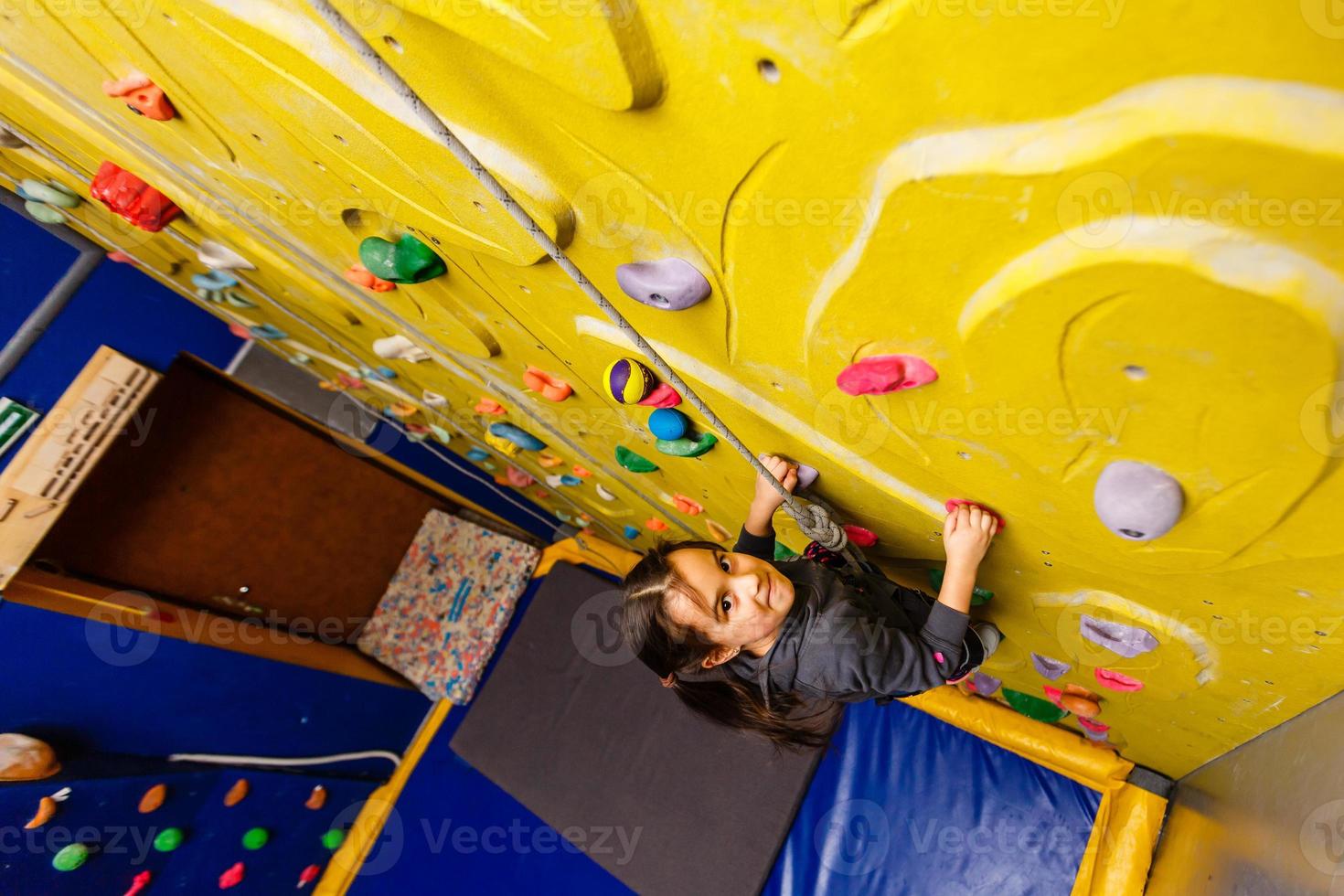 Little Girl Climbing Rock Wall photo