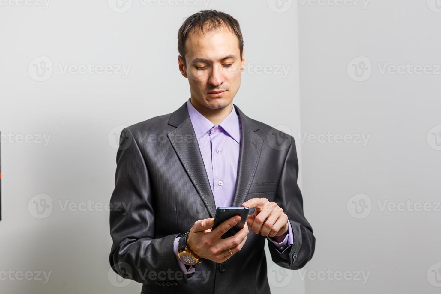 Smiling Young Middle Eastern Man With smartphone photo