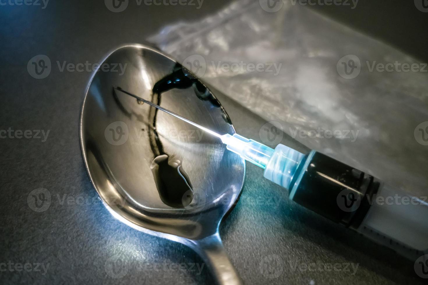 Hard crystal drugs and prohibited substances, syringes, cooked heroine spoon on brown table. close up image on substances. Drug abuse and addiction concept. International Day against drug abuse photo