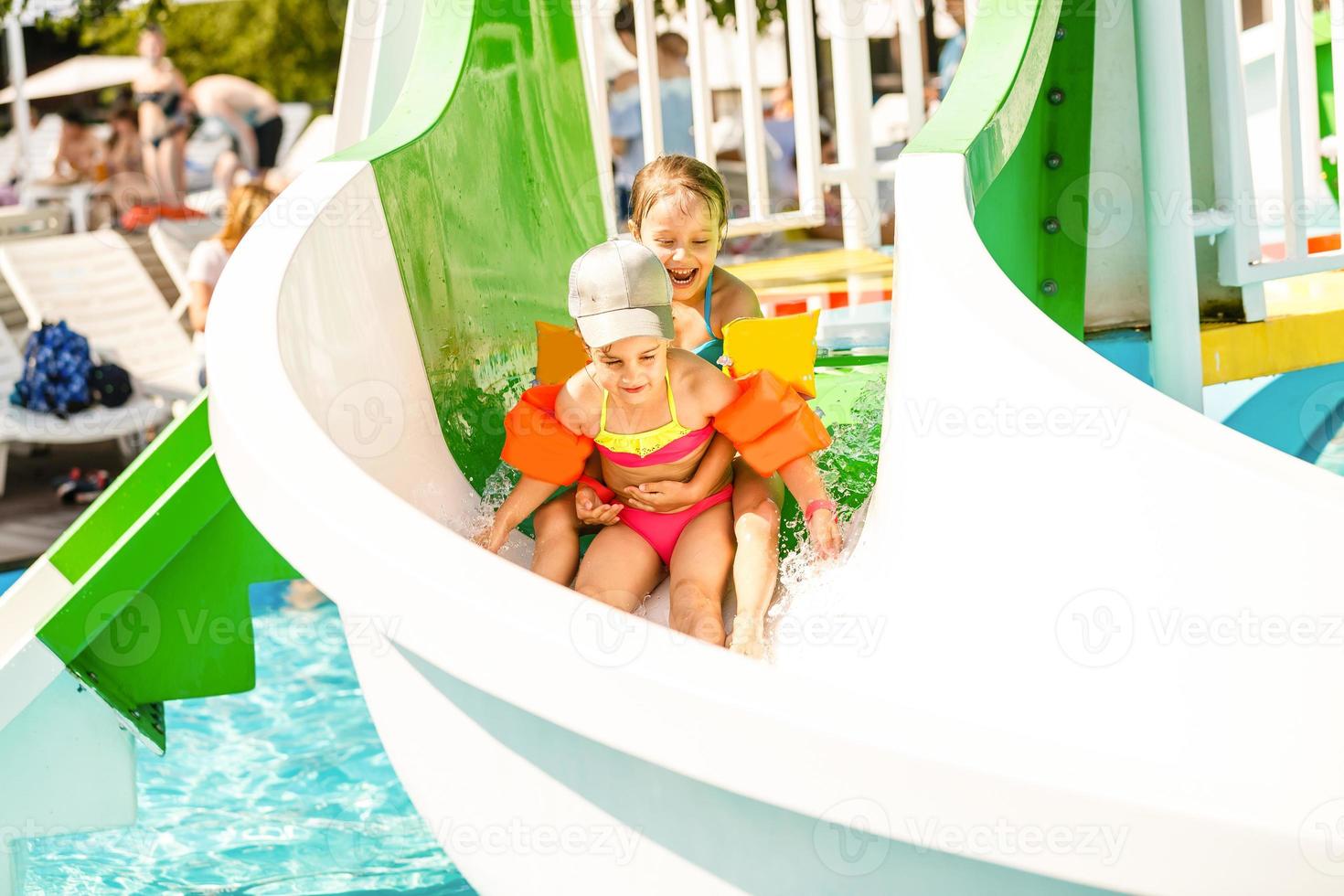 two little kids playing in the swimming pool photo