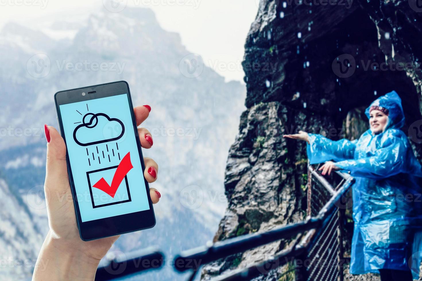 Female holding a smartphone and using Google Weather application on the screen photo