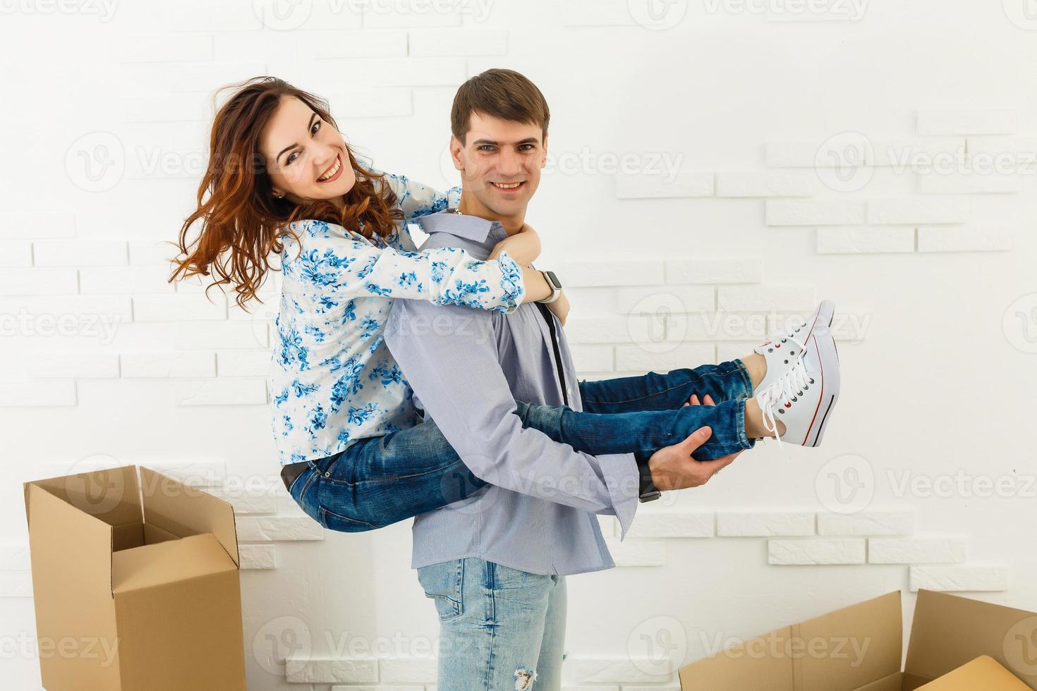 Young couple resting from moving into a new home. Great copy space. photo