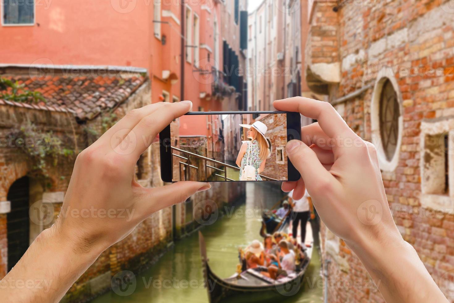 Taking pictures on mobile smart phone in Gondola on Canal Grande with Classic old house in the background, Venice, Italy photo