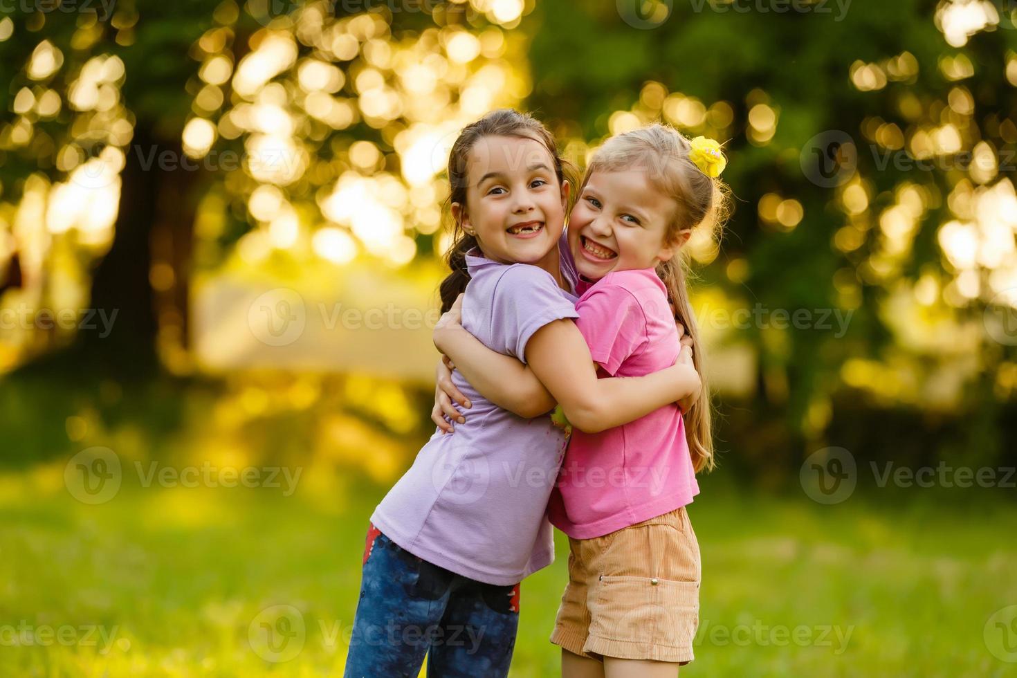 Summer fun. little girls play in the field photo