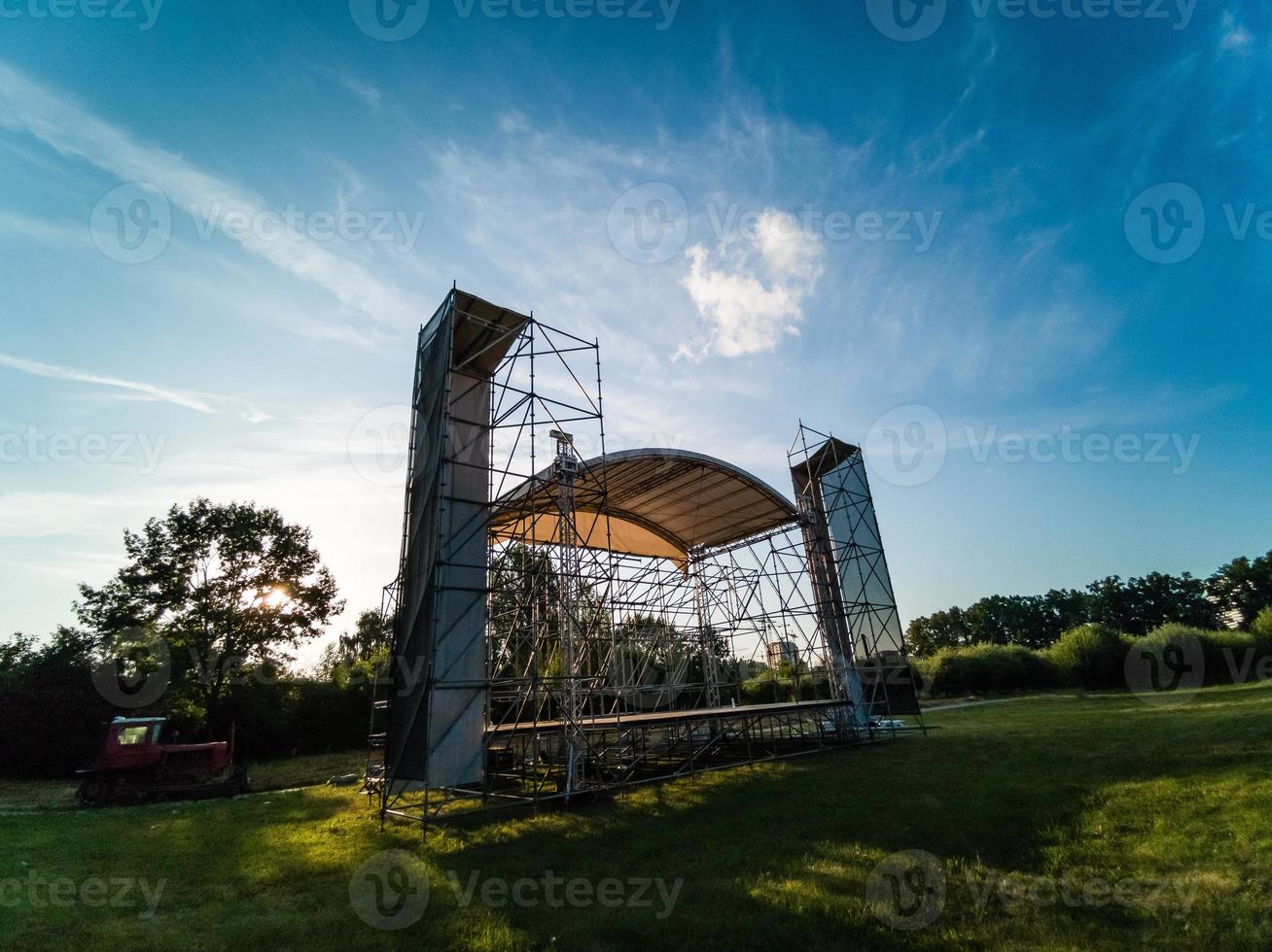 Assembling the big stage on grass of stadium photo