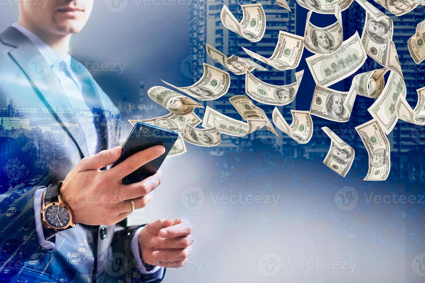 Technology online banking money transfer, e-commerce concept. Happy young man using smartphone with dollar bills flying away from screen isolated office background photo