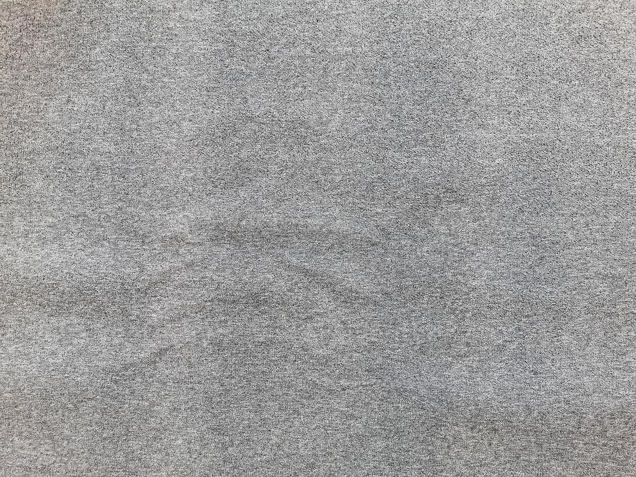 Seamless close up of monochrome grey carpet texture background from above photo