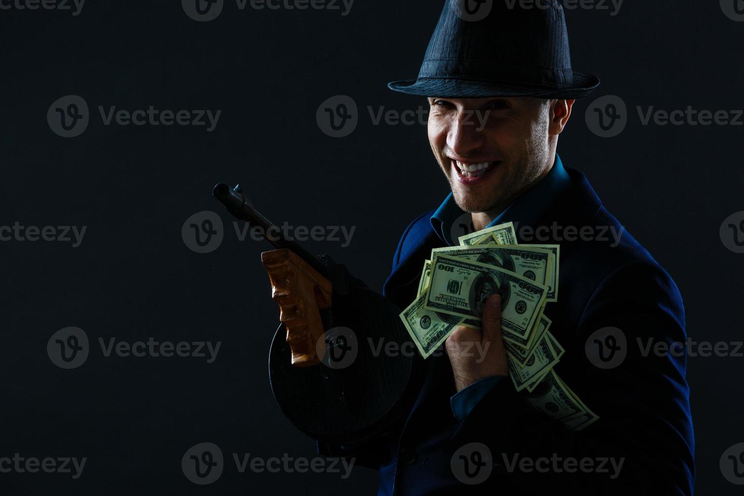 Man taking dollars banknotes with stealthy expression against grunge background photo