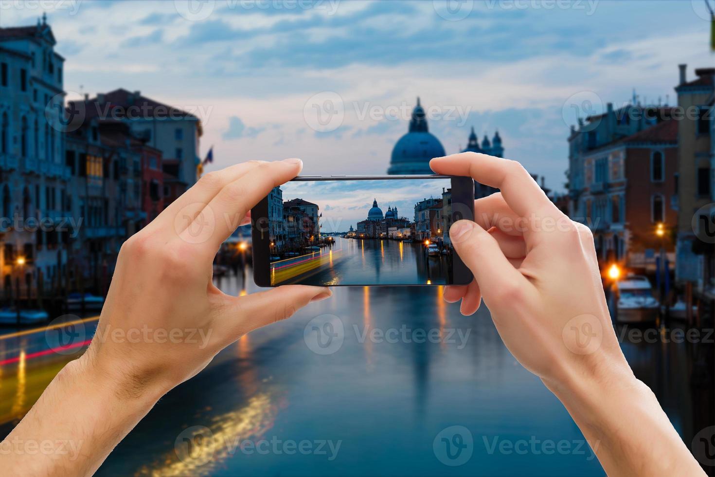 Traveler tourist taking beautiful landscape photo of european sunset during holiday vacation