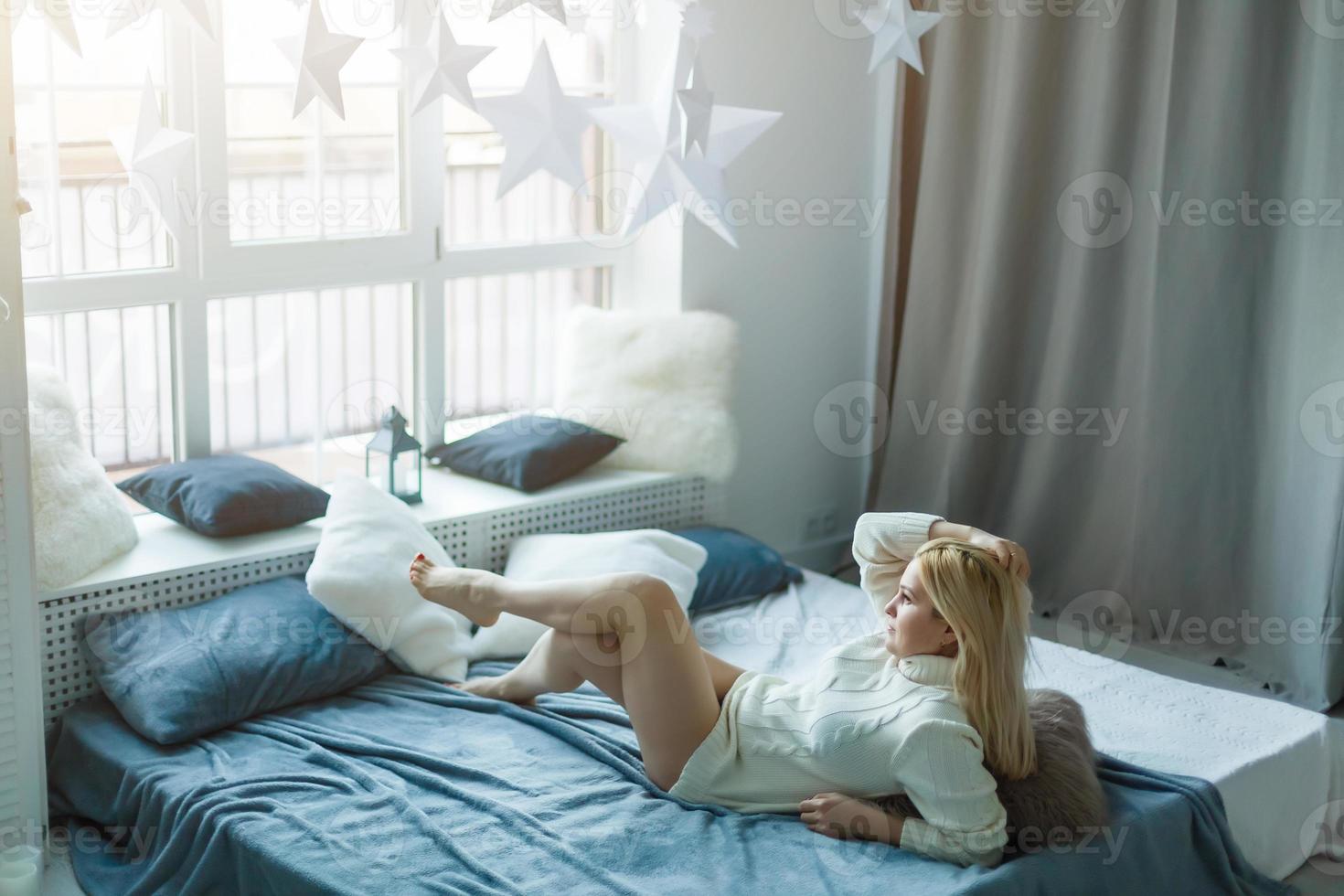 Relaxed young woman lying on couch photo