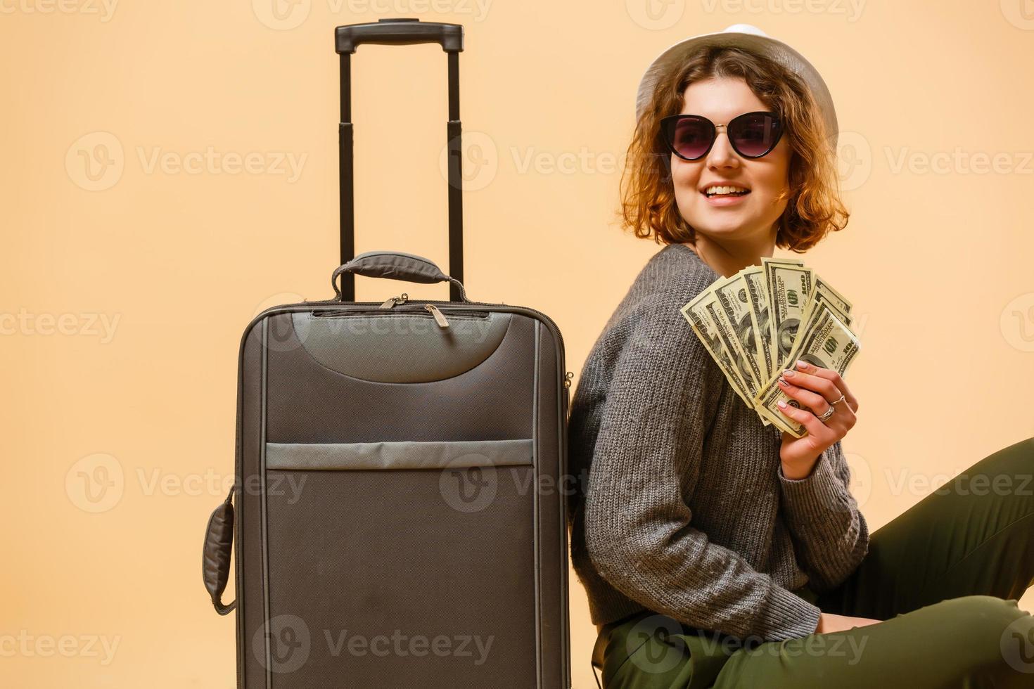 Close up tourist woman in summer casual clothes, hat at suitcase passport cash money isolated on yellow background. Passenger traveling abroad to travel on weekends getaway. Air flight concept photo