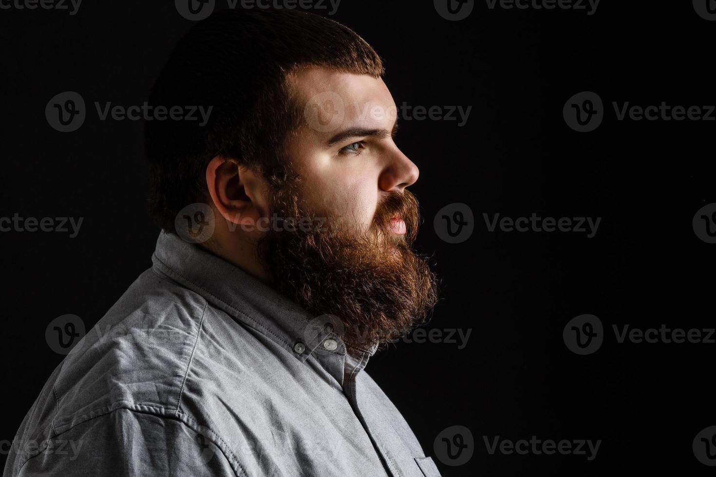 Serious fashionable man with beard mustache in suit. Mens beauty, fashion. Fashion portrait of hipster man.with beard touching his mustache. photo