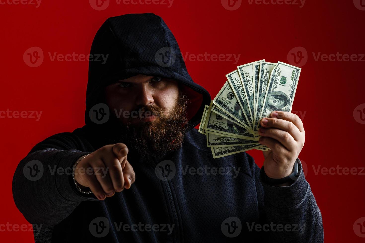 Attractive multiethnic man in style classy jacket trendy stand under money fly rain isolated on red vivid background raised hands up photo