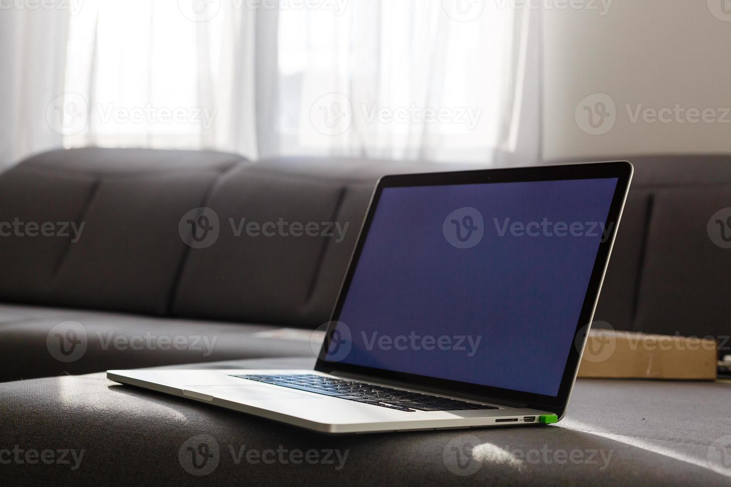 laptop on the sofa with nobody, concept of working at home photo