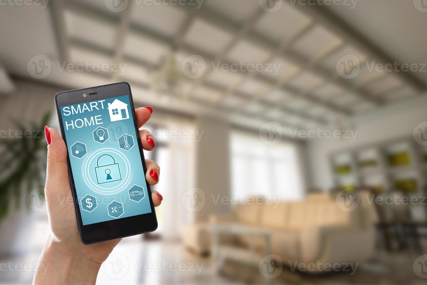 Smart home technology interface on smartphone app screen with augmented reality view of internet of things  connected objects in the apartment interior, person holding device photo