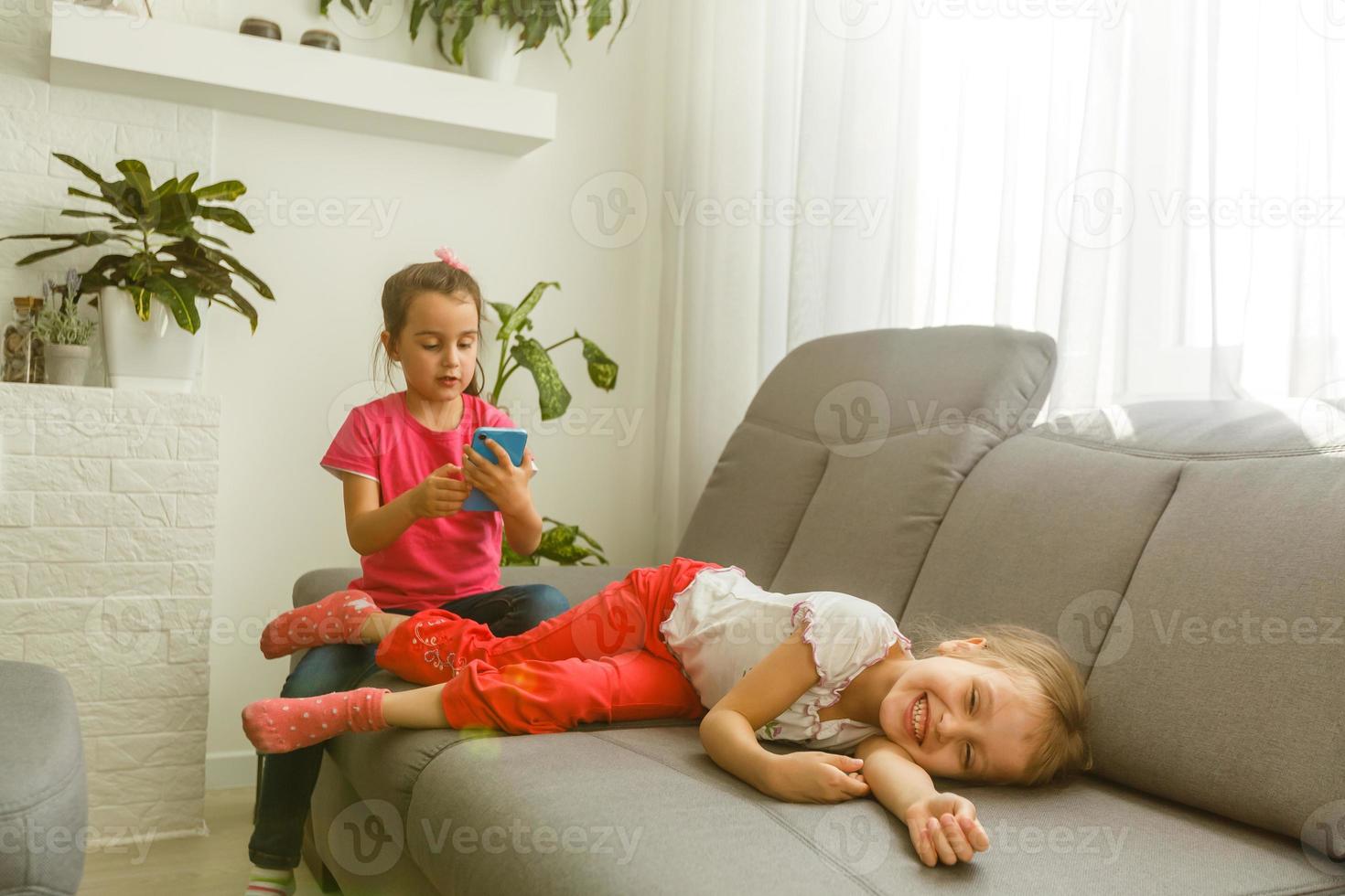 Two little girls are playing at home. Childhood photo