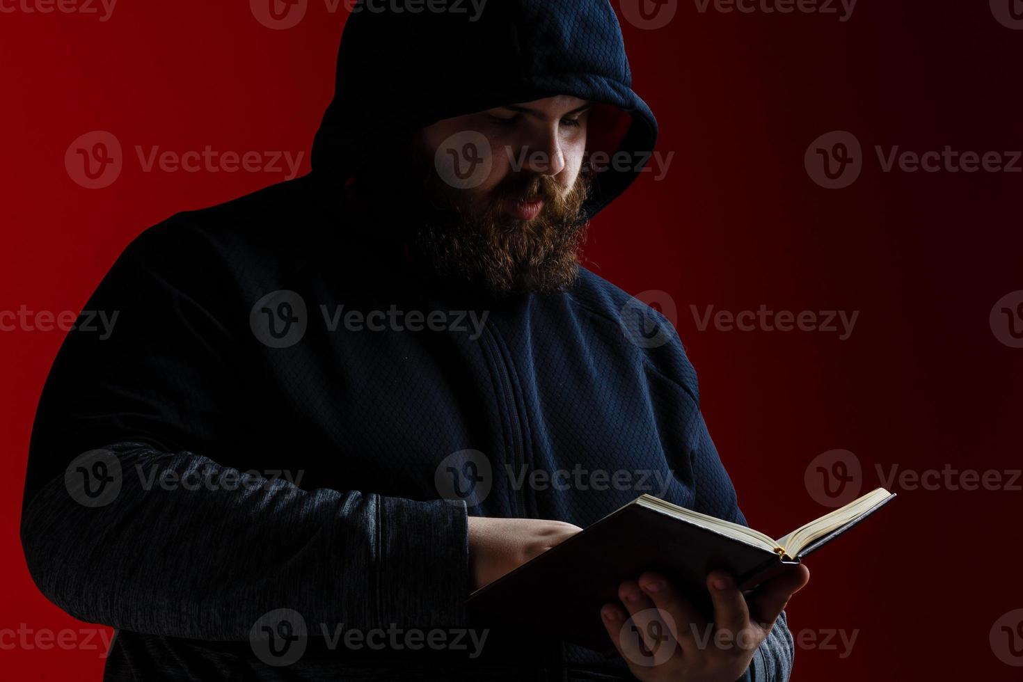 man in a suit holding a book photo