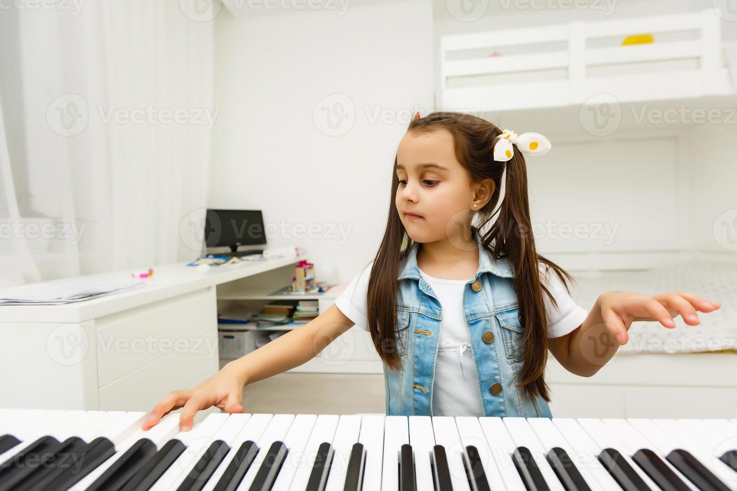 girl long hair practicing piano photo