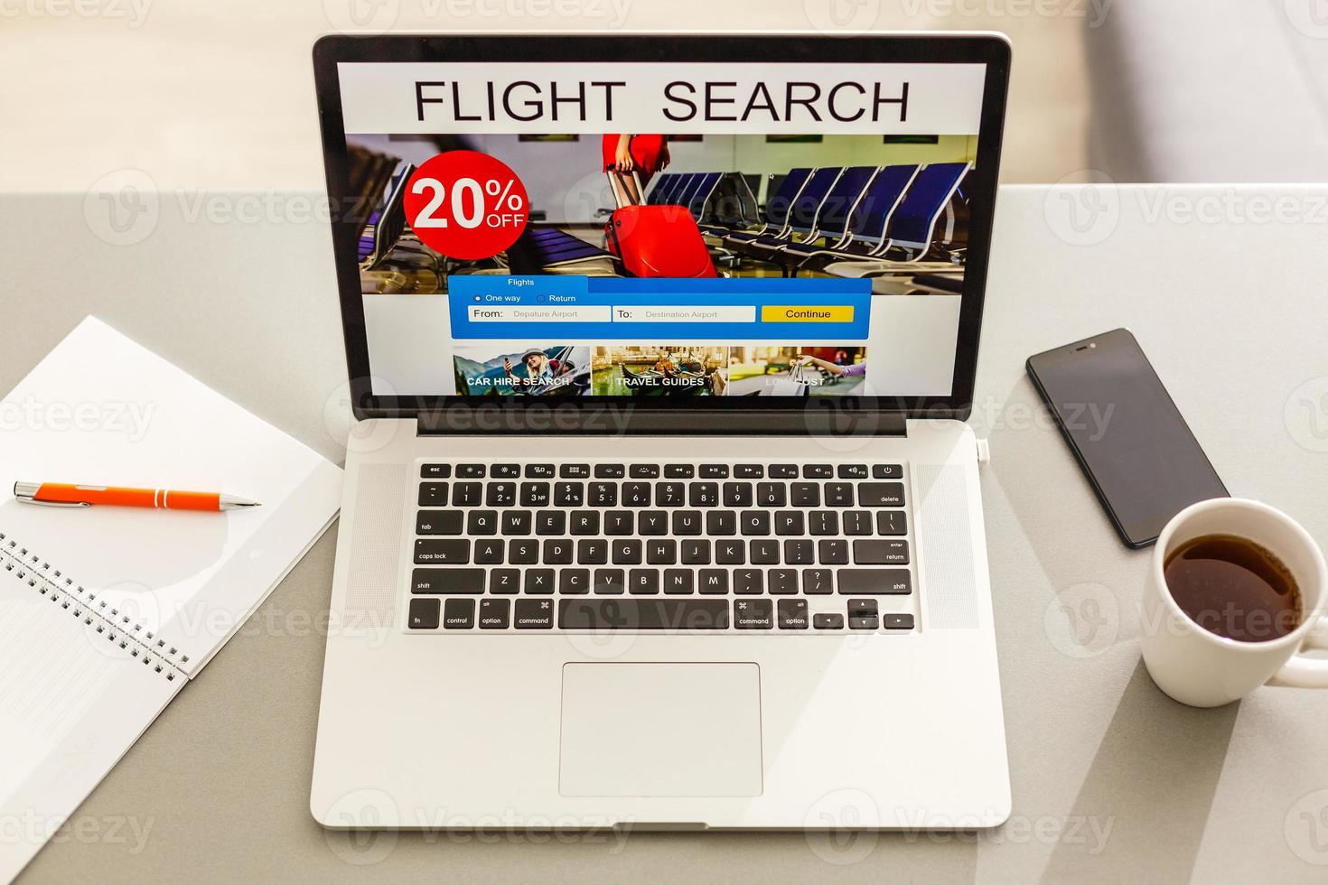 Flights online booking and reservation. Search flights on a computer laptop screen, office desk background. photo