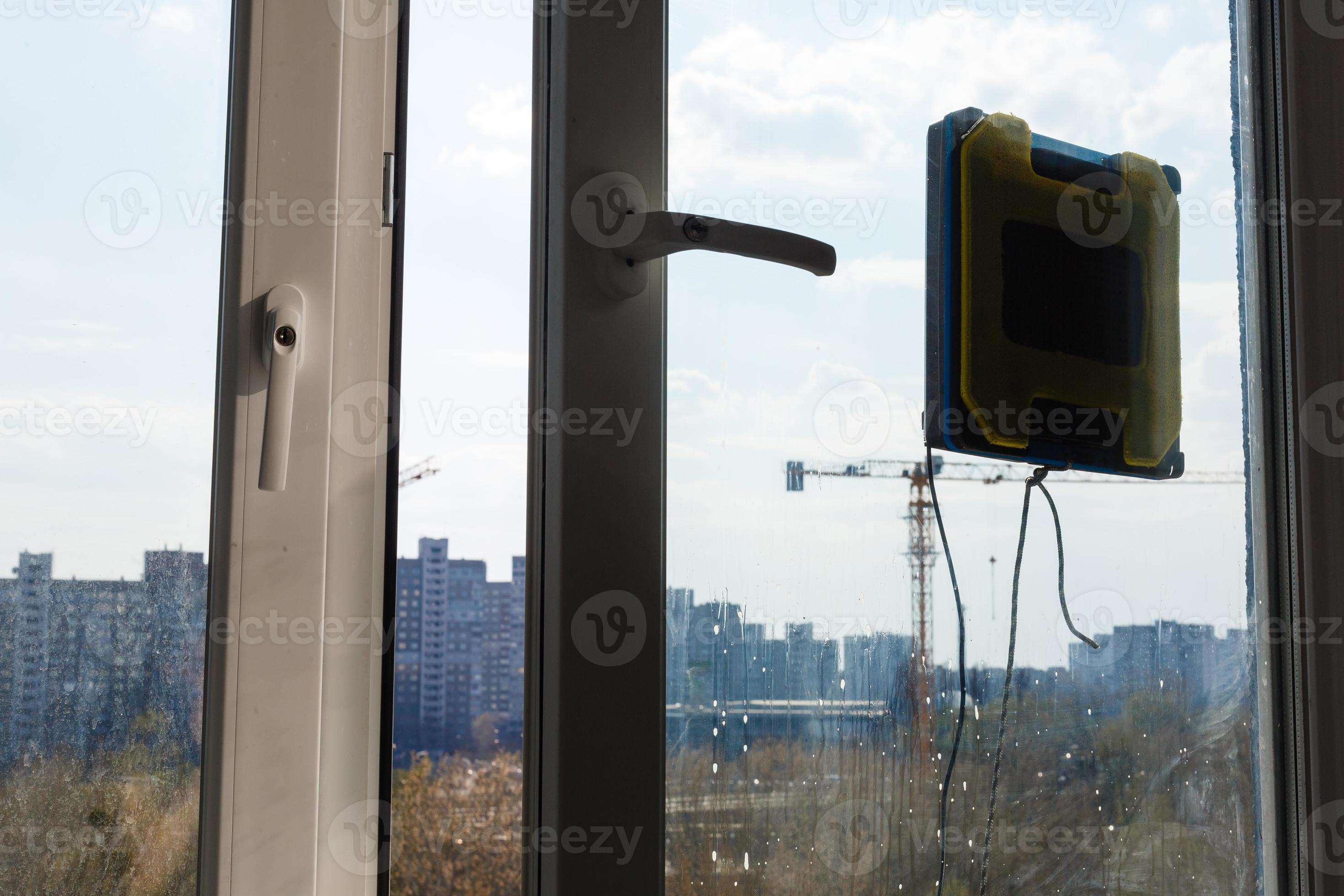 Robot window cleaner work on dirty window. Cleaning the house with