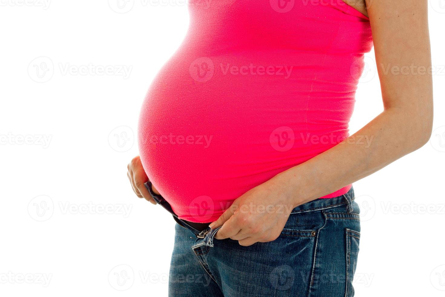 studio portrait of pregnant woman in pink shirt isolated on white background photo