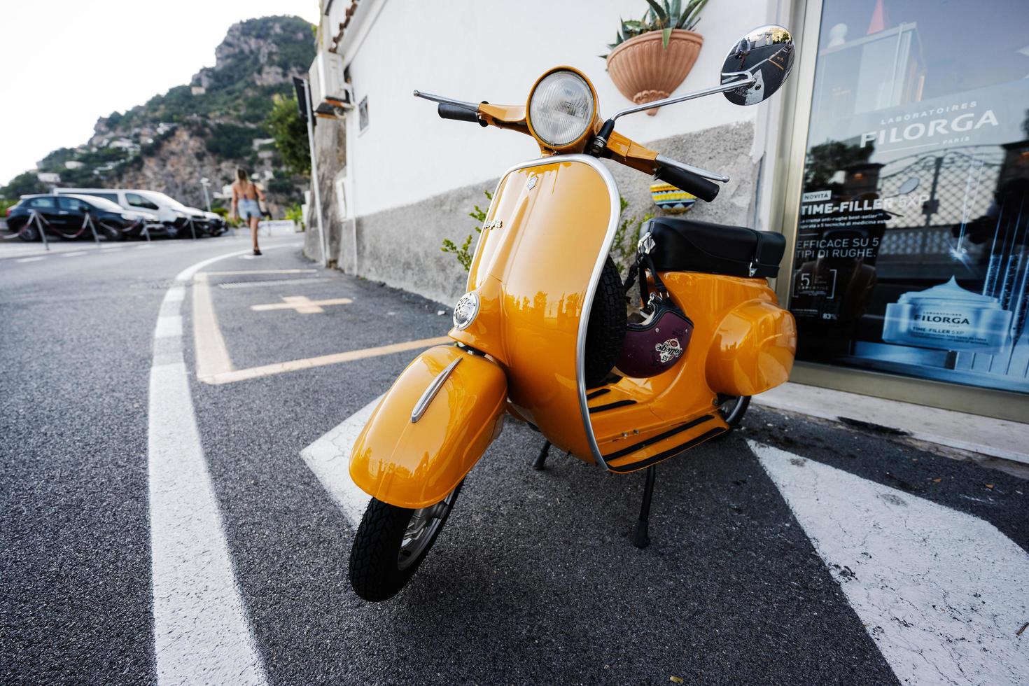 1964 vintage yellow Vespa scooter on road of Positano, Italy. photo