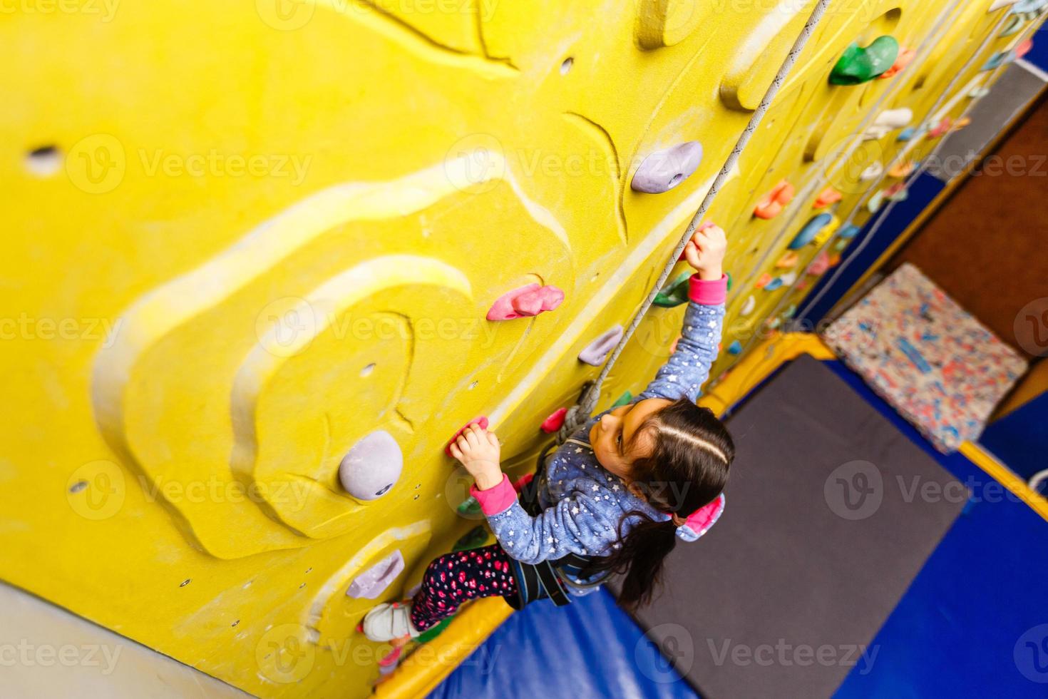 Little Girl Climbing Rock Wall photo