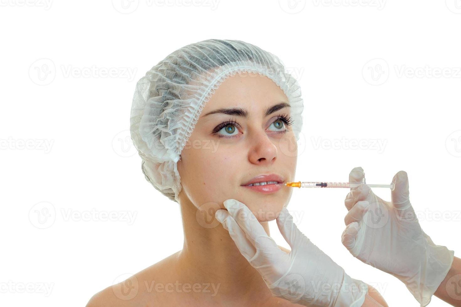 Portrait of a cute young girl in medical CAP which the doctor inserts a vaccine on the face closeup photo