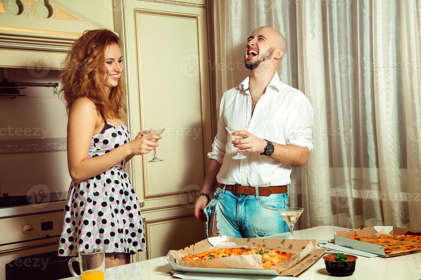 Attractive couple having party fun, drinking, laughing photo