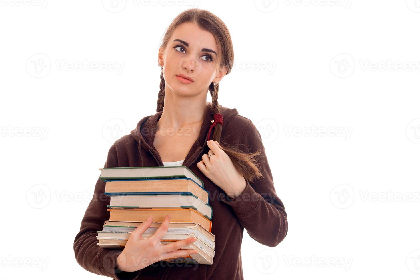 tired young students girl with books in her hands isolated on white background photo