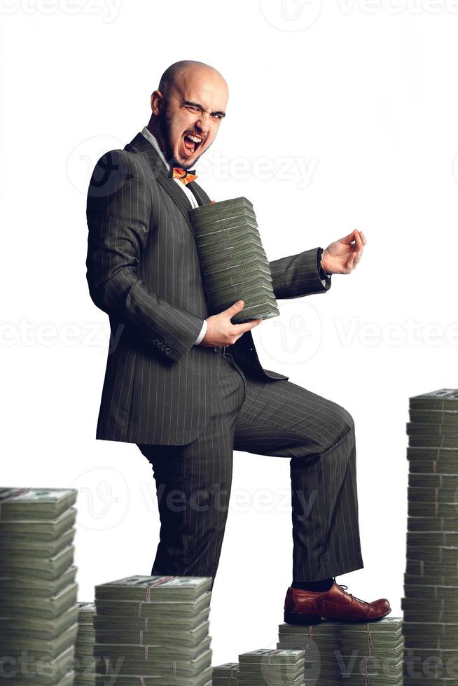 Isolated on white background rich man in an expensive suit with a bunch of money around and in the hands photo