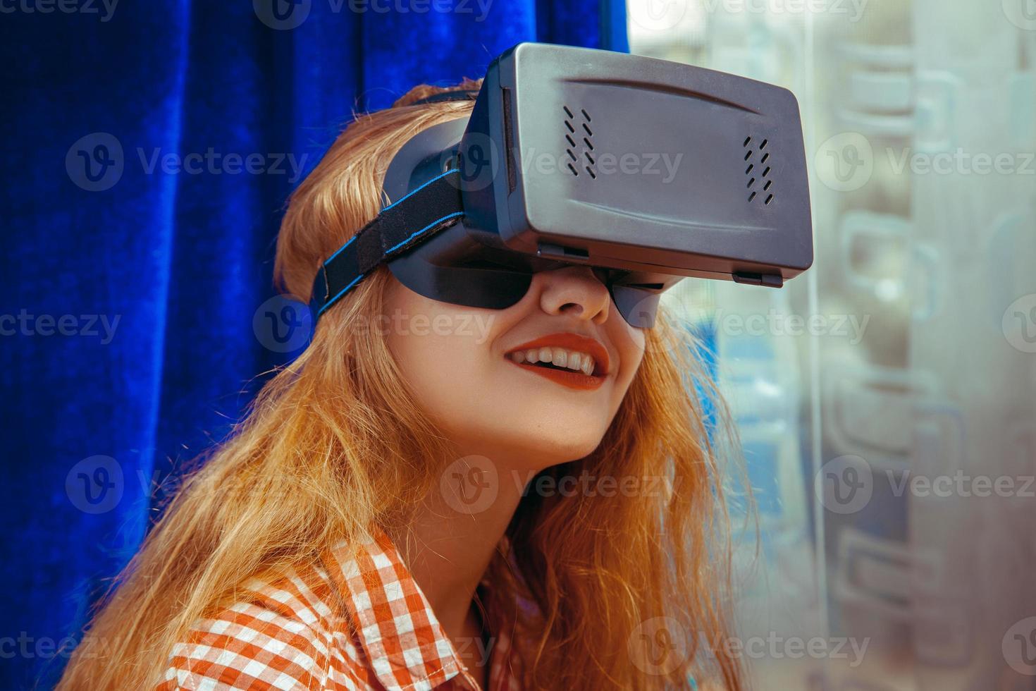 young attractive woman in virtual reality helmet photo