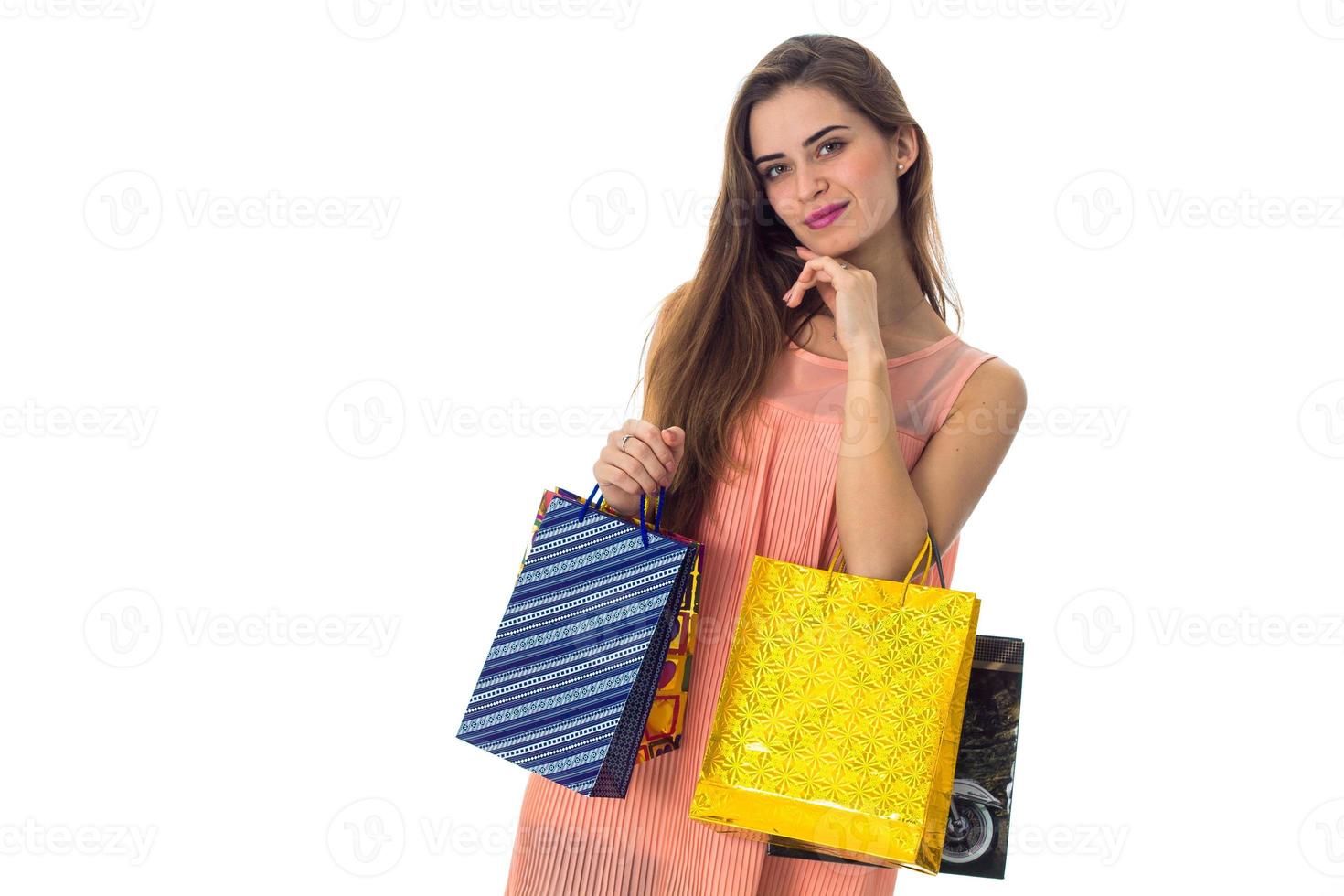 young girl holding blue and yellow bags isolated on white background photo
