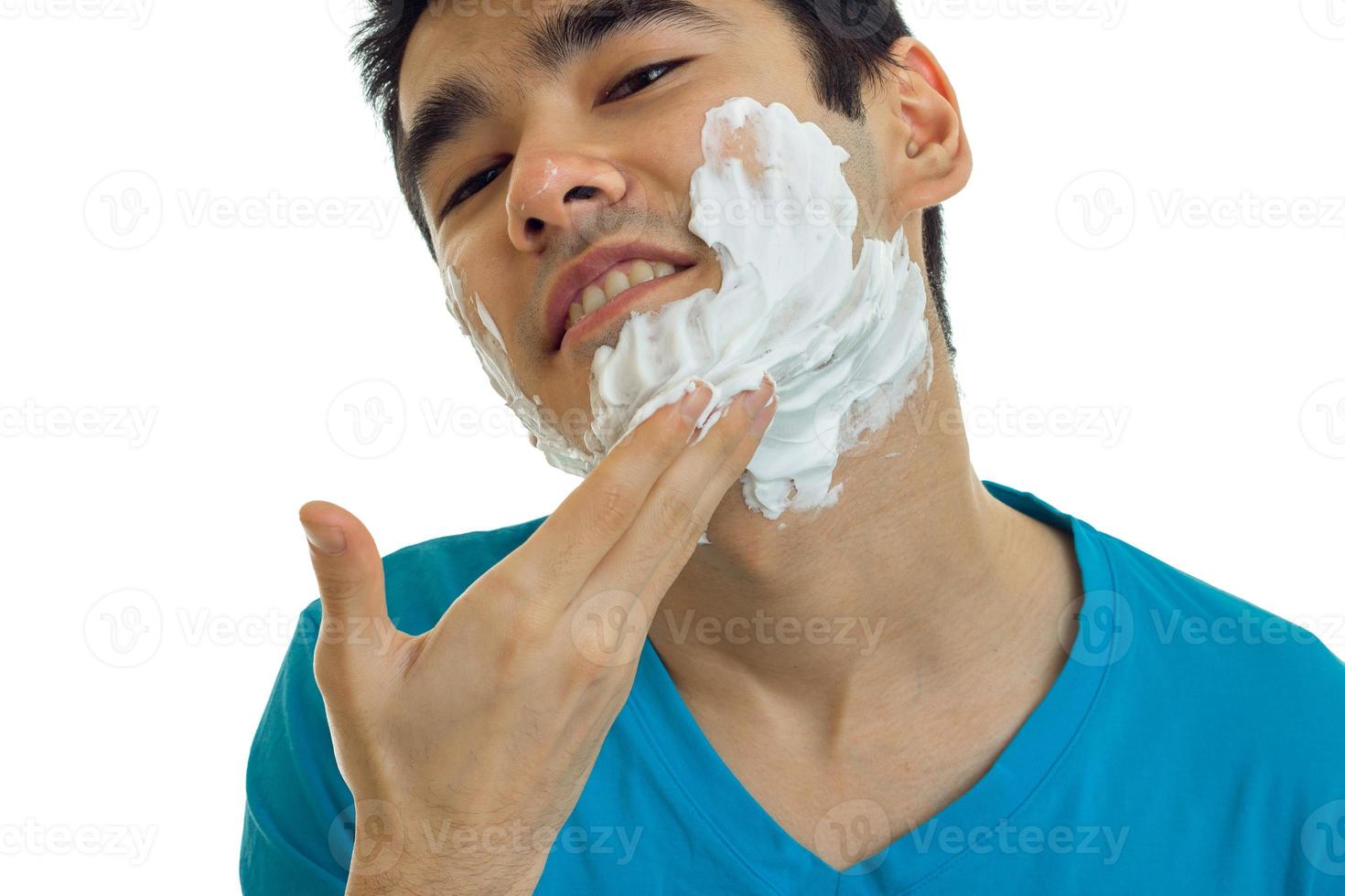 a close-up portrait of the beautiful smiling guy with foam on his face photo