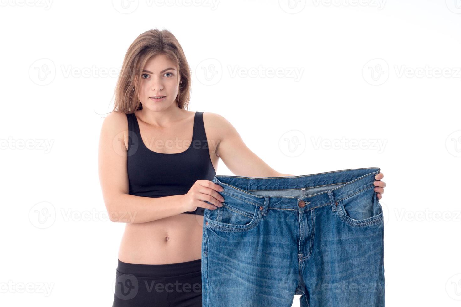 girl stands and holding a big wide pants photo