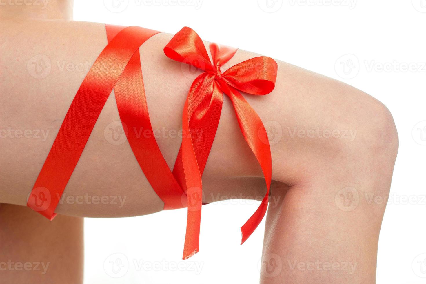 long Red Ribbon at the foot of some girl close-up photo