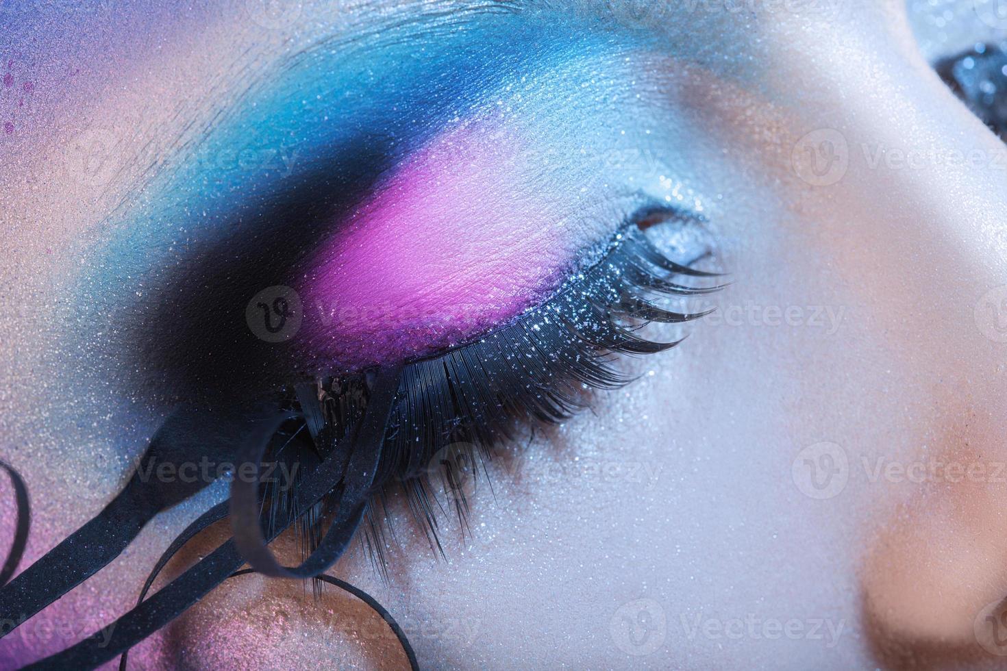 Macro photo of closed woman eye with multicolor make up