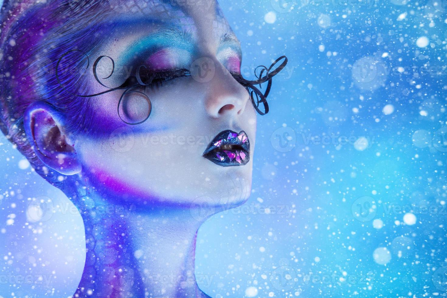Snowing photo of beauty woman with closed eyes and creative body art