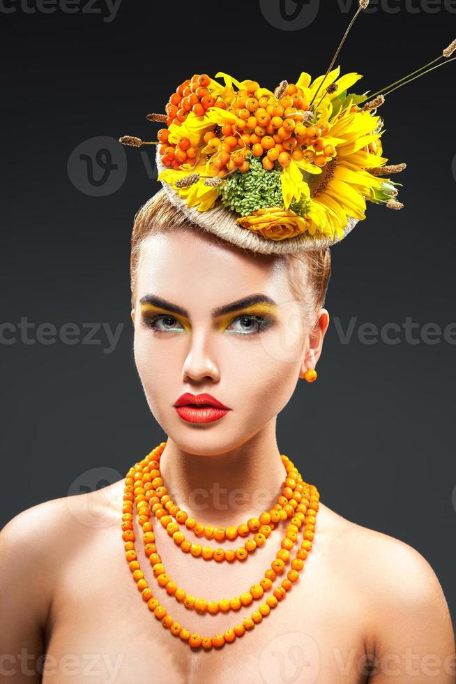 Bouquet of flowers and rowan on head and rowanberry on neck in studio photo