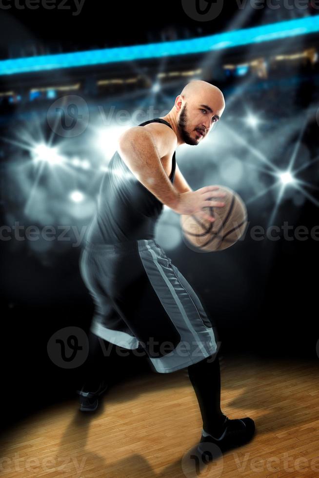 Player in basketball on the floor with ball in hands looking away photo