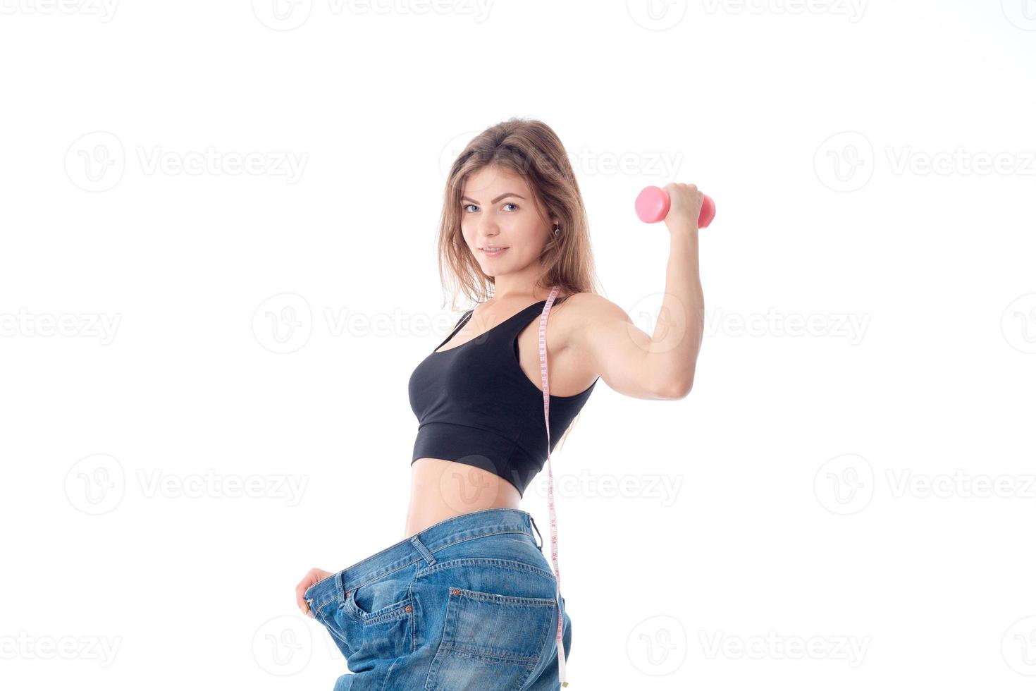 Sports girl wore slacks and shows the biceps on hand isolated  white background photo