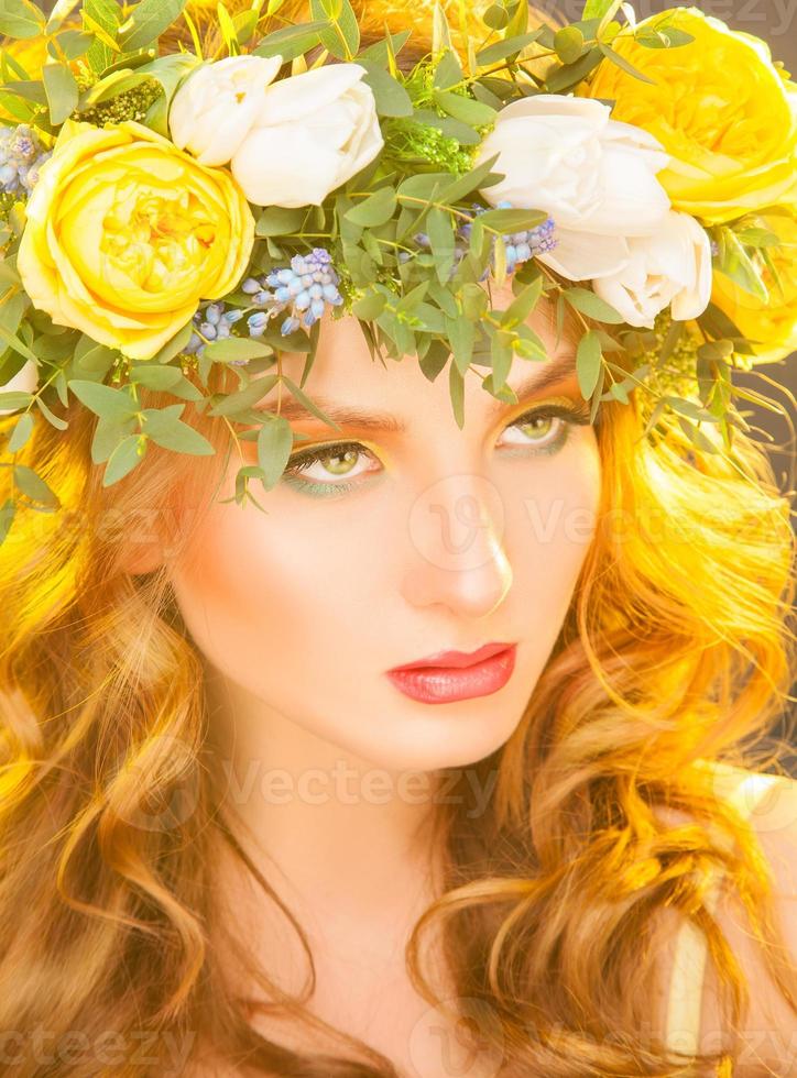 Cute woman with flowers on hair looking away photo