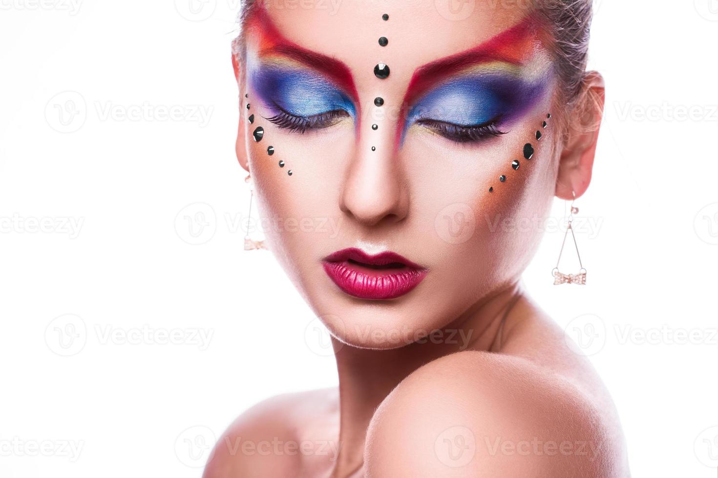 Sensual portrait of pretty adult female with closed eyes and multicolor make up photo