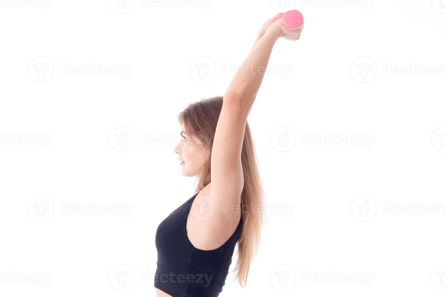 Fitness woman in black sports top holding the dumbbells photo