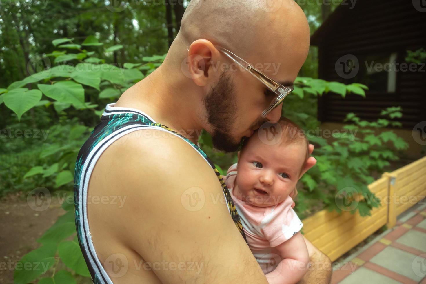 Cute little baby in Daddy's arms photo