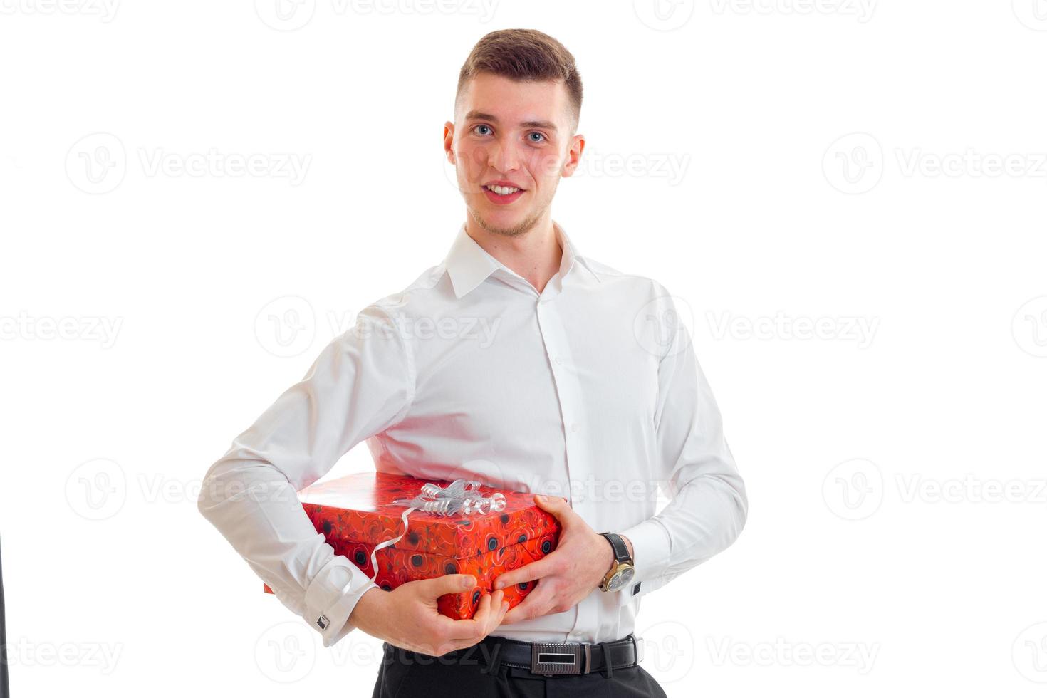 young tall guy in a white shirt holding a red gift box photo