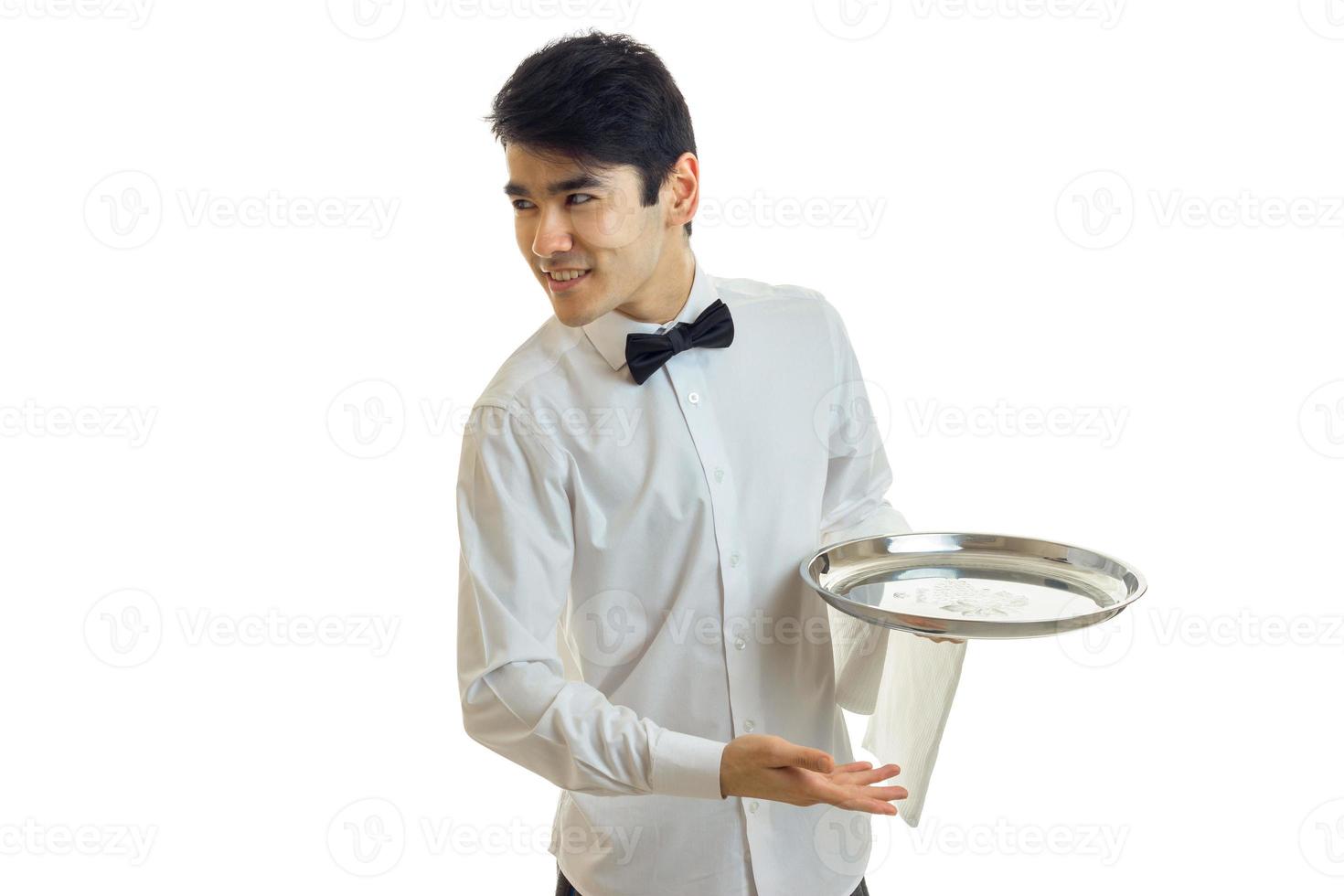 handsome young waiter's shirt smiling looks to the side and holding a tray photo